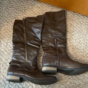 Brown boots that almost go up to the knee